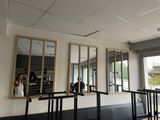 three mirrors hanging on the wall of a restaurant