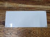 a white sign on a wooden table on a wooden floor