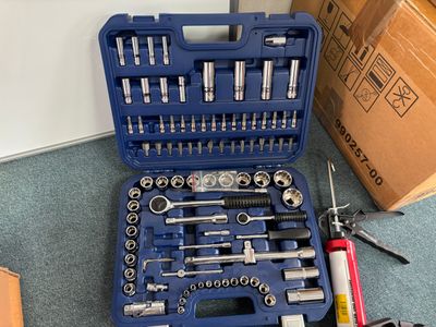a tool kit that is sitting on the floor next to a box