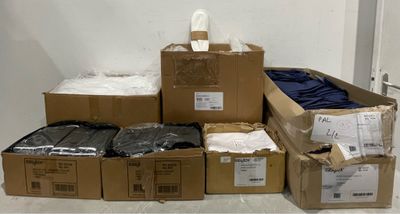 a pile of boxes and boxes of clothing on the floor