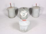 three buckets with lids and handles are sitting next to each other