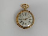 an antique gold pocket watch with roman numerals and roman numerals on the face