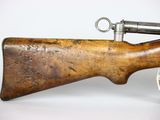 an old rifle with a wooden barrel on a white background