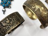 three different types of bracelets and rings on a white surface