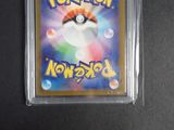 a close up of a pokemon trading card in a plastic case