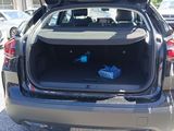 the back end of a car with the trunk open and two bags in the trunk