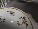 many plates and bowls sitting on a table