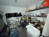 a kitchen with a lot of dishes and utensils on the shelves