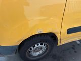 a yellow van that is parked in a parking lot
