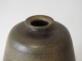 a brown vase sitting on a table with a white background