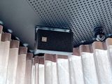 two speakers that are attached to the ceiling of a vehicle