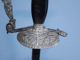 a close up of a sword on a stand with a blue background