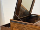 a wooden box with a mirror on top of it