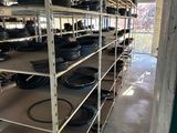 many shelves with pots and pans on them in a room