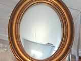 a mirror that is hanging on the wall in the bathroom