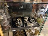 a glass display case filled with silverware and silverware