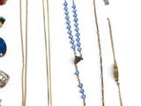 many different types of necklaces on a white surface
