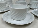 a lot of cups and saucers on the table