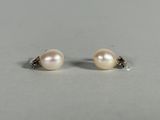a pair of pearl and diamond stud earrings