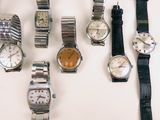 a lot of watches that are sitting on a table