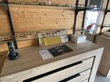 a desk with a laptop on top of it in a room