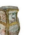 a vase with a floral design on it on a white surface