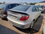 a silver car parked in a parking lot next to other cars