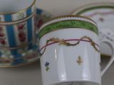 two cups and a saucer sitting on a table
