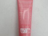 a close up of a tube of sunscreen cream on a table