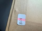 a sticker on a piece of cardboard with a cat drawn on it