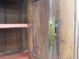 a wooden cabinet with a door open on the floor