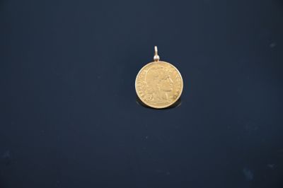 a gold coin is shown on a black surface