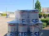 several cans of beer stacked on top of a pallet in a parking lot