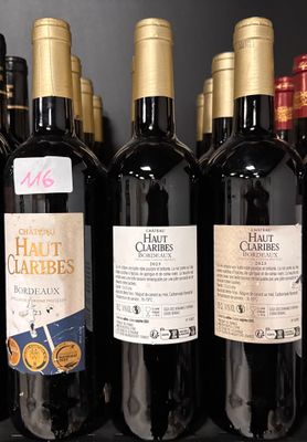 bottles of wine are lined up on a shelf in a store