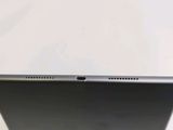 the back of a laptop computer sitting on top of a white table