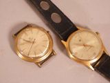 two watches sitting next to each other on a table