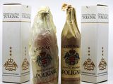 three bottles of liquor sitting next to each other on a white surface