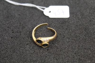 a close up of a gold ring with a black stone on it