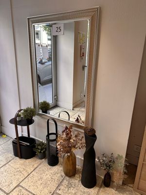 two vases and a mirror on the floor in a room