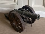 a cannon sitting on the floor in front of a door