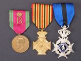 three medals and a medal on a table with a coin