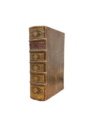 an old book sitting on top of a white surface