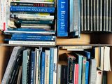 a box full of books that are stacked on top of each other