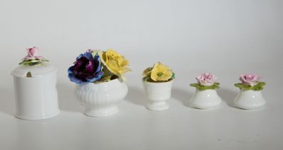 four small vases with flowers in them on a table