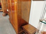a wooden cabinet and a small table in a room