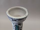 a close up of a small vase on a table