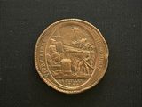 an image of a gold coin with a picture of a man on a horse drawn carriage