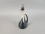 a black and white vase with a light on top of it