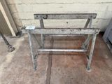 a metal bench that is sitting on the ground