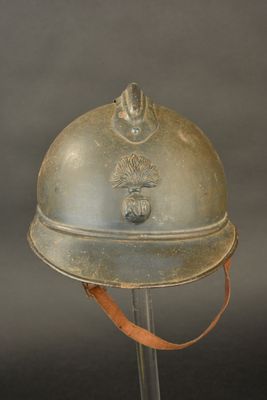 a silver helmet with a red ribbon on it